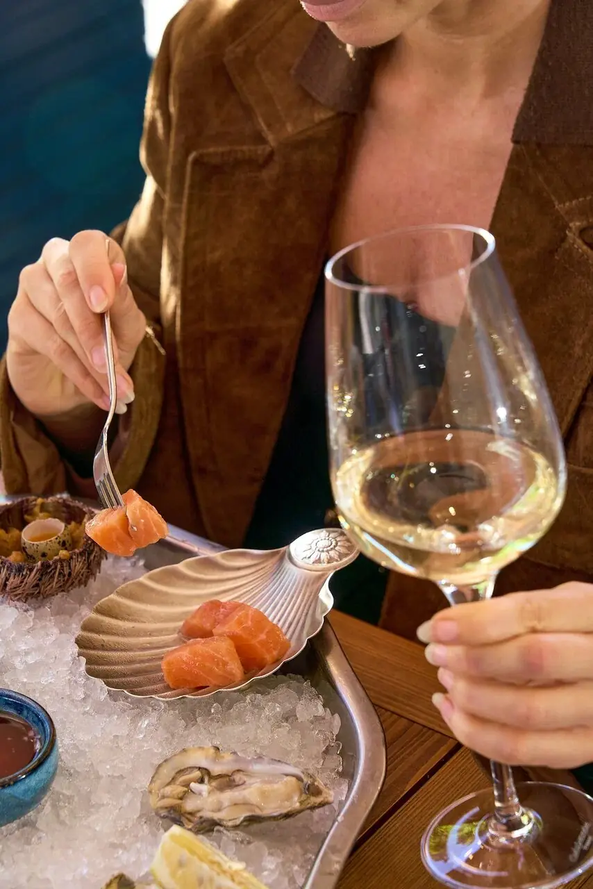 Guests enjoying oysters and white wine